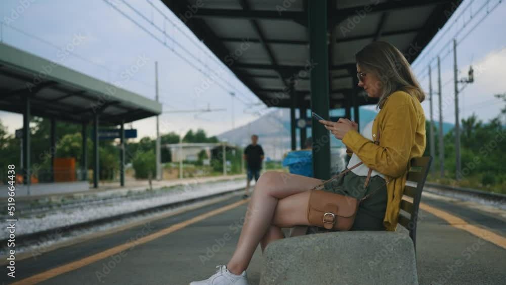 Woman sitting and waiting for her train. Woman sitting and waiting for her train.