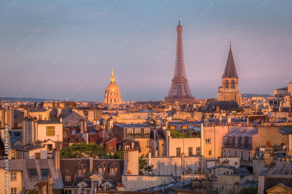 Eiffel tower and parisian roofs at sunrise Paris, France