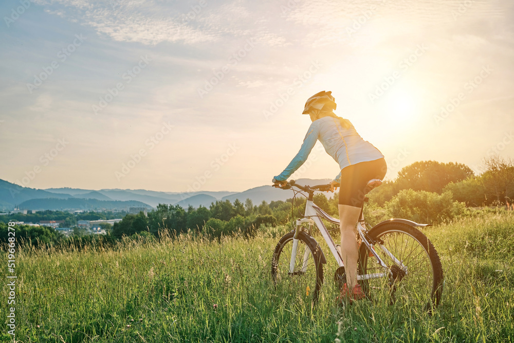 Cyclist Woman riding bike in helmets go in sports outdoors on sunny day a mountain in the forest. Silhouette female at sunset. Fresh air. Health care, authenticity, sense of balance and calmness.
Cyclist Woman riding bike in helmets go in sports outdoors on sunny day a mountain in the forest. Silhouette female at sunset. Fresh air. Health care, authenticity, sense of balance and calmness.