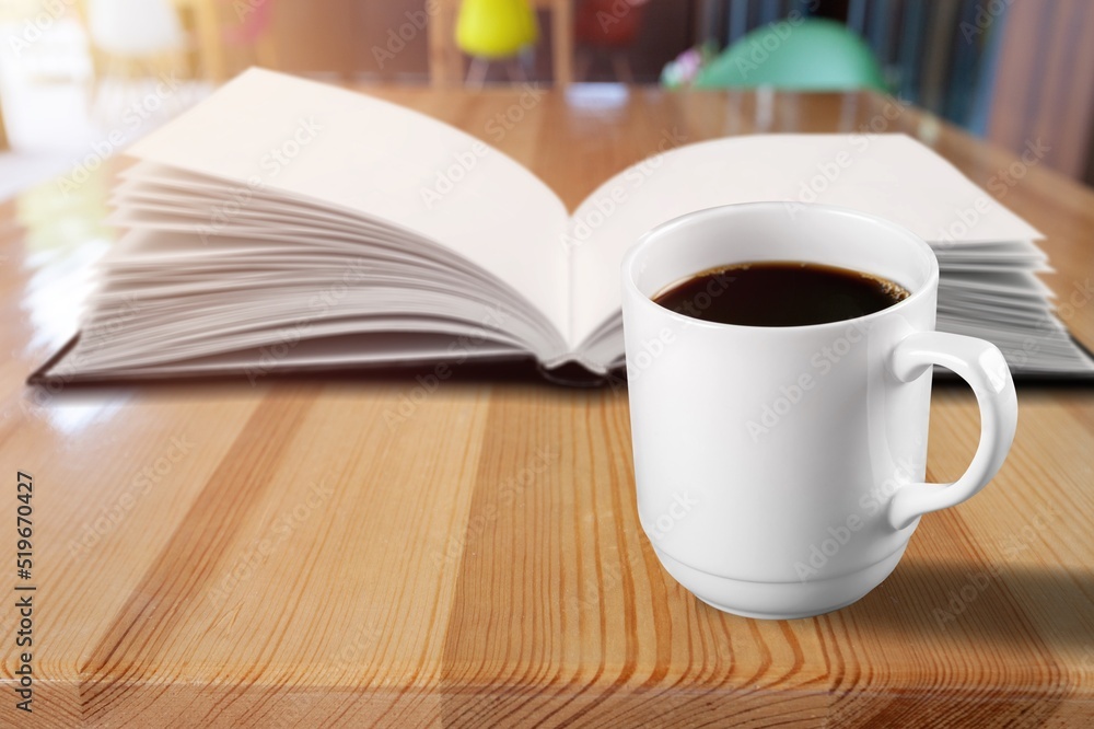 Reading book at home with a cup of coffee. Relaxation mood, cultural activity. Freedom, information, knowledge concept. Reading book at home with a cup of coffee. Relaxation mood, cultural activity. Freedom, information, knowledge concept.