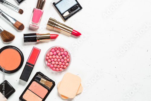 Makeup professional cosmetics, decorative cosmetic on white marble background. Flat lay image with copy space.