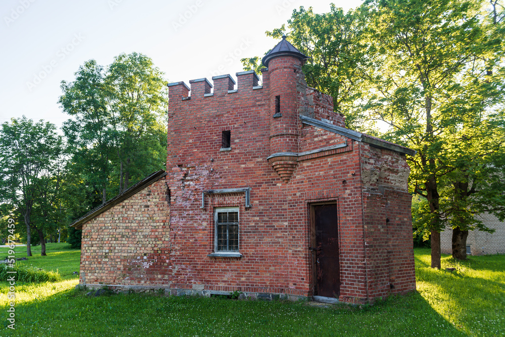 Mound red brick gatekeeper's house. It looks like a small castle. Lasi, Latvia.