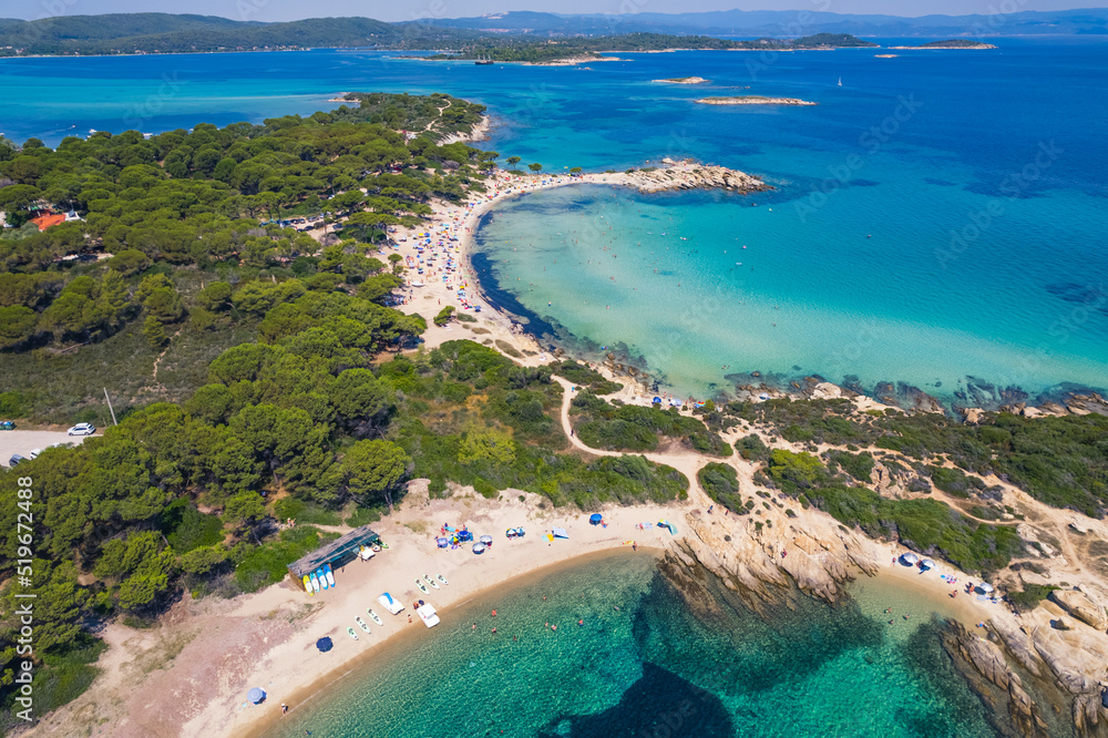 Karydi Beach seen from aerial drone view. Amazing natural water colors - turquoise and dark blue. Sunny weather. High quality photo