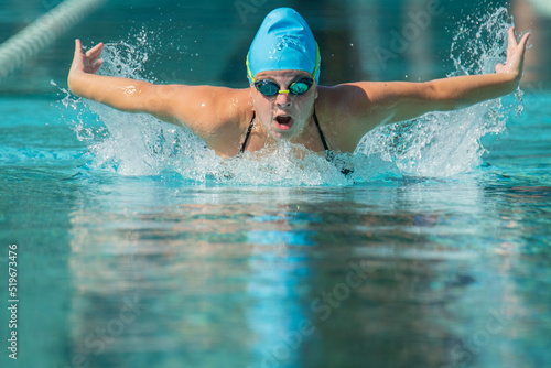 Young female athlete swims butterfly © Michael O'Neill