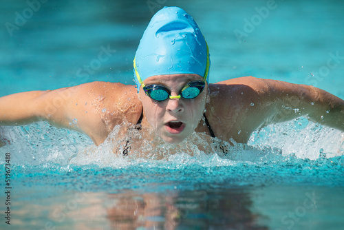 Female teenage swimmer doing butterfly