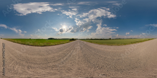 360 hdri panorama on no traffic gravel dusty road among fields with fluffy clouds in full seamless spherical equirectangular projection, may use like sky replacement for drone panorama