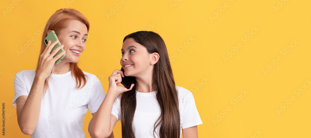 Mother and daughter kid banner, copy space, isolated background. voice contact. happy woman and girl talk on smartphone. family connection. Mother and daughter kid banner, copy space, isolated background. voice contact. happy woman and girl talk on smartphone. family connection.