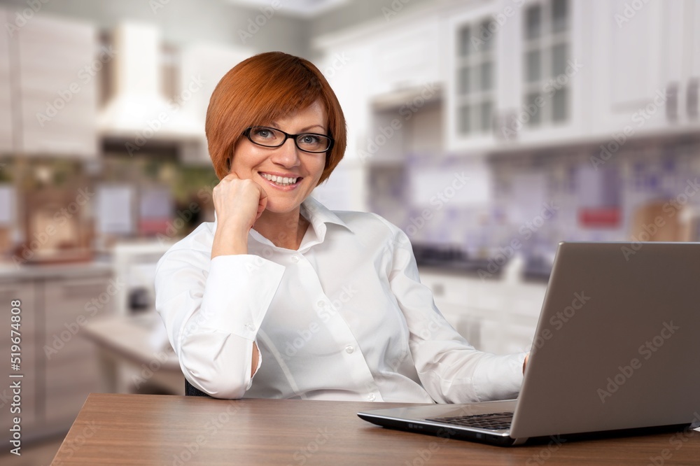 Happy young woman student learning at home looking at laptop computer watching online webinar, having virtual work meeting Happy young woman student learning at home looking at laptop computer watching online webinar, having virtual work meeting