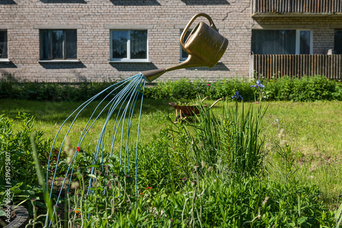 Garden decoration with watering can and water, Latvia photo