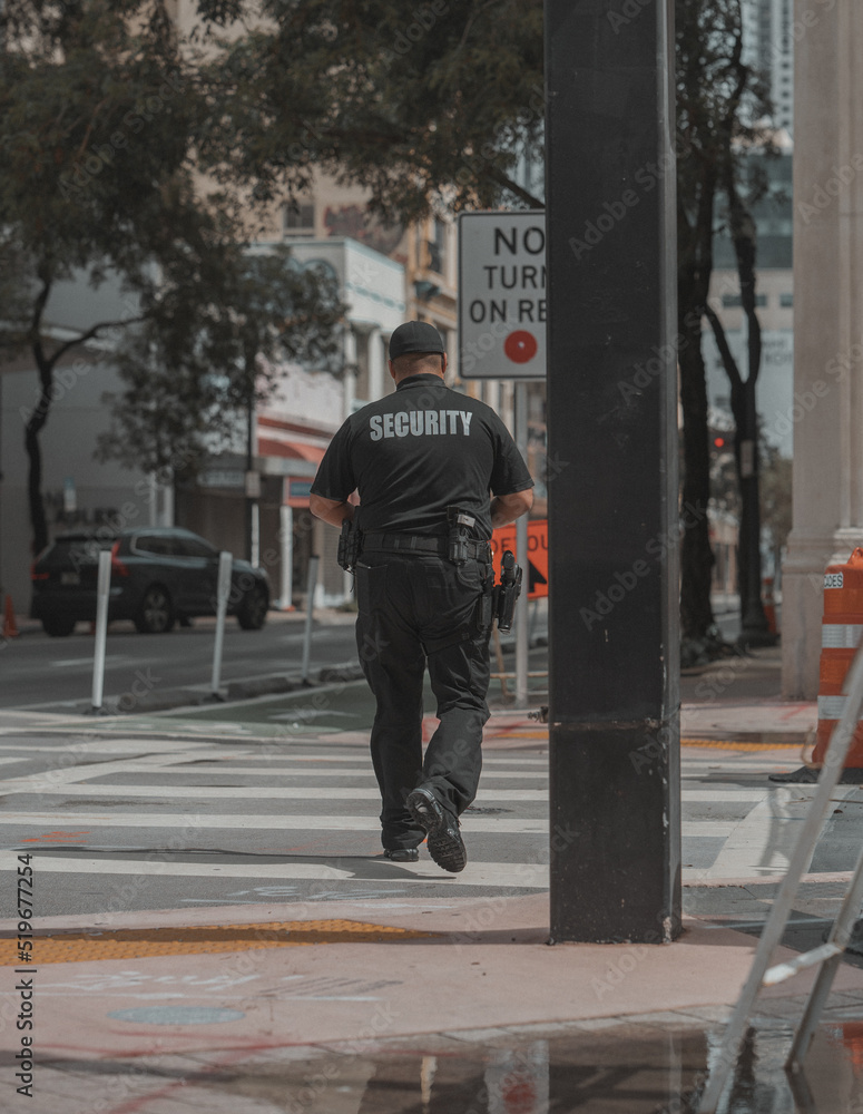 walking on the street security work downtown miami 
