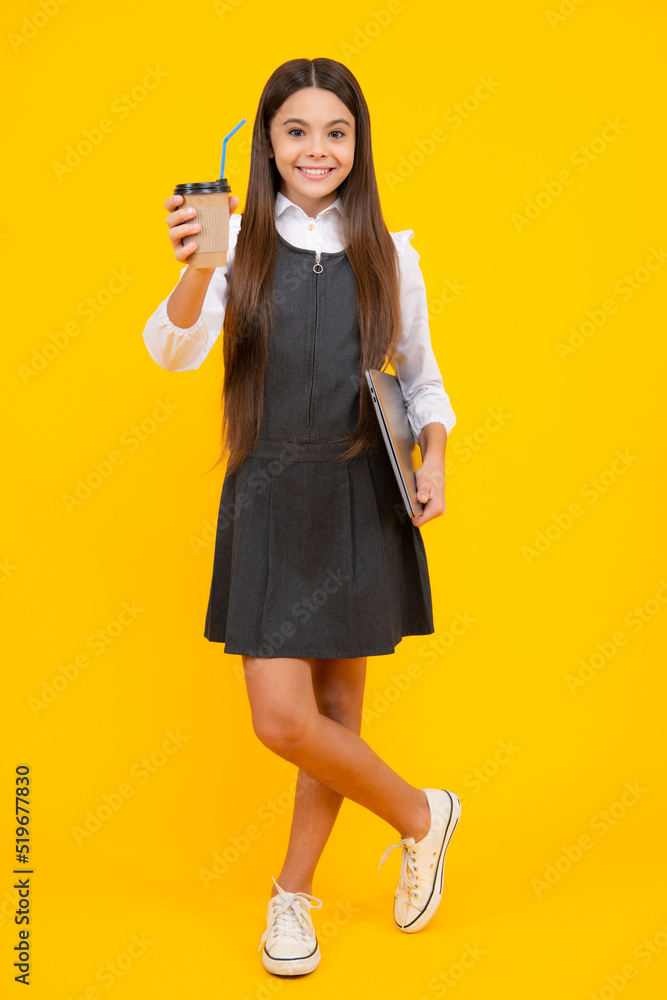 Teenager child with coffee cup isolated on yellow studio background. Girl drinking take away beverage. Teenager child with coffee cup isolated on yellow studio background. Girl drinking take away beverage.