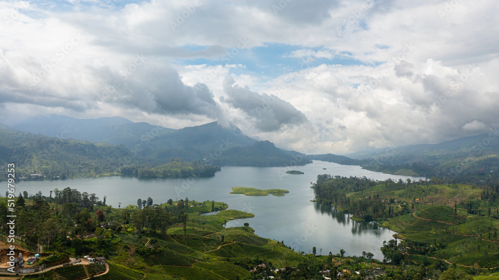 Obraz premium A town among tea plantations and a lake in the mountains. Maskeliya, Maussakelle reservior, Sri Lanka.