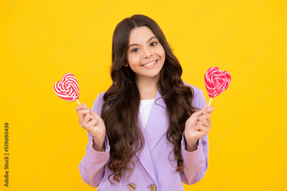 Teenager girl with caramel candies on sticks, sweet sugar addiction. Child with lollipops. Happy teenager, positive and smiling emotions of teen girl. Teenager girl with caramel candies on sticks, sweet sugar addiction. Child with lollipops. Happy teenager, positive and smiling emotions of teen girl.