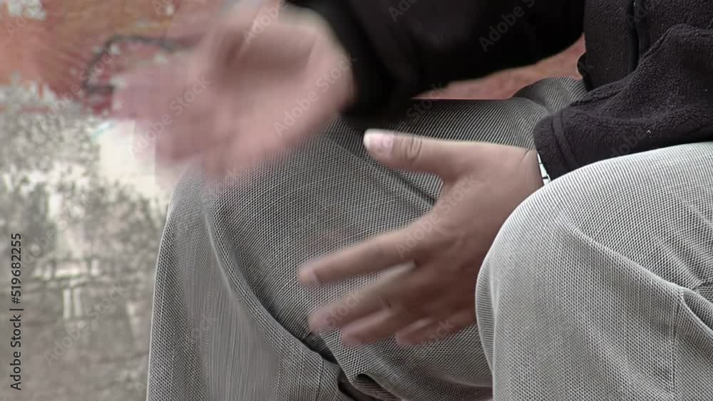 Man Sitting Outside while Talking with Someone. Close Up. Man Sitting Outside while Talking with Someone. Close Up.
