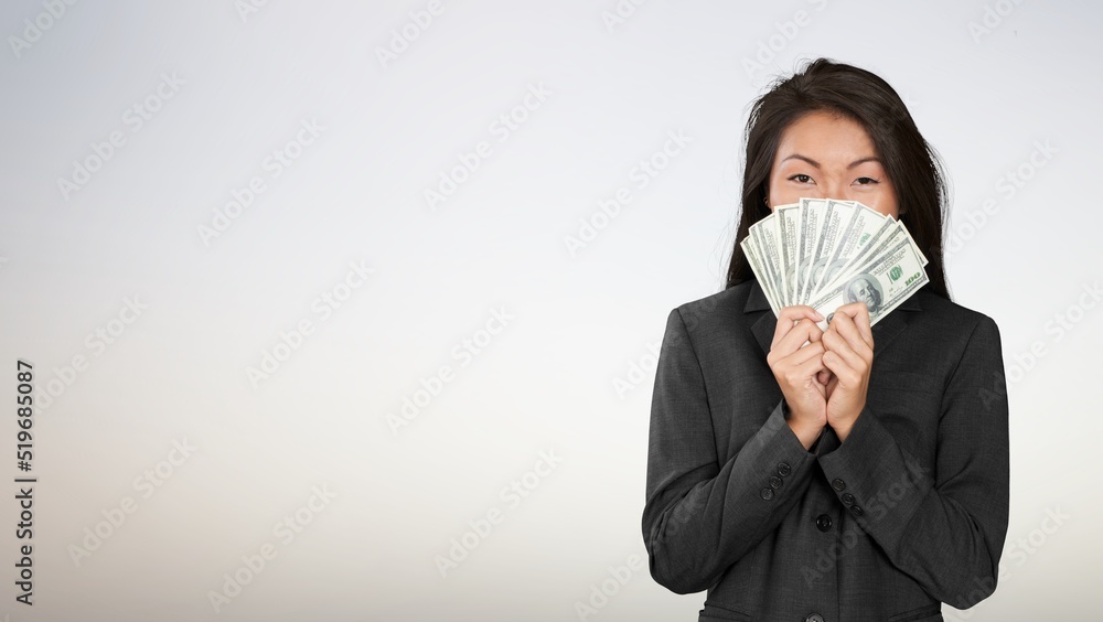 Smiling young modern woman holding cash money dollars Smiling young modern woman holding cash money dollars