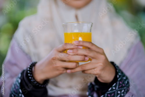 Islamic girl drinking orange juice
