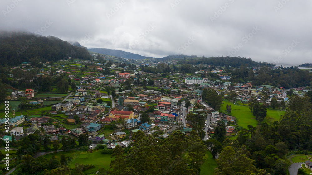 The town of Nuwara Eliya is covered with clouds among green hills and mountains. Sri Lanka.