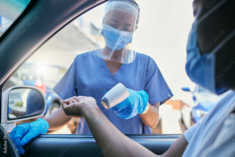 Fever, temperature and Covid test at drive through station in a car. Professional nurse or doctor screening patient with a thermometer. Wellness and safety of people through a pandemic Fever, temperature and Covid test at drive through station in a car. Professional nurse or doctor screening patient with a thermometer. Wellness and safety of people through a pandemic