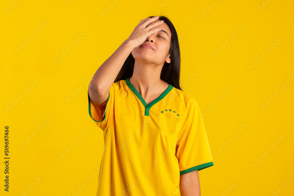 Young woman wearing the official uniform shirt of the Brazilian soccer