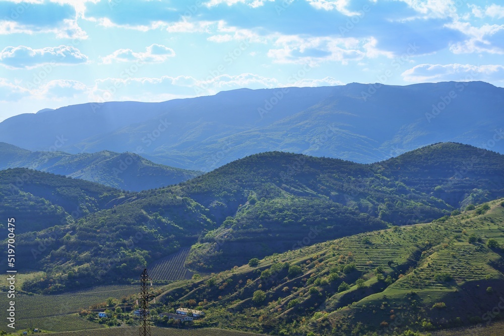 Panoramic view of a summer evening in the mountains, green meadows, mountain and hills Panoramic view of a summer evening in the mountains, green meadows, mountain and hills