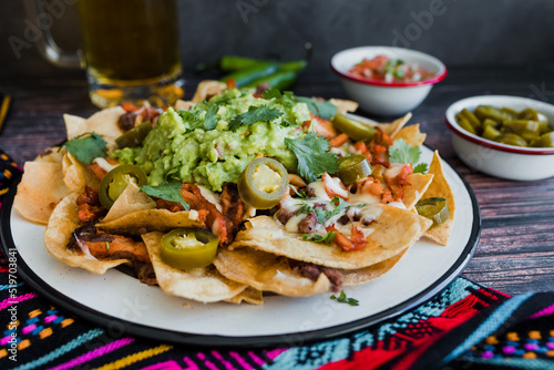 Mexican nachos chips with american cheese and avocado, traditional food in Mexico Latin America 