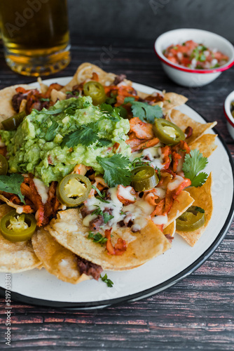 Mexican nachos chips with american cheese and avocado, traditional food in Mexico Latin America 