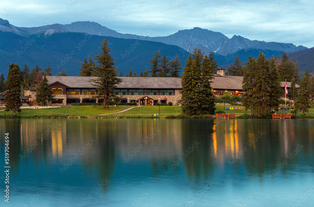 Fototapeta premium Reflection of Jasper Lodge facade in Beauvert Lake, Jasper national park, Alberta, Canada.