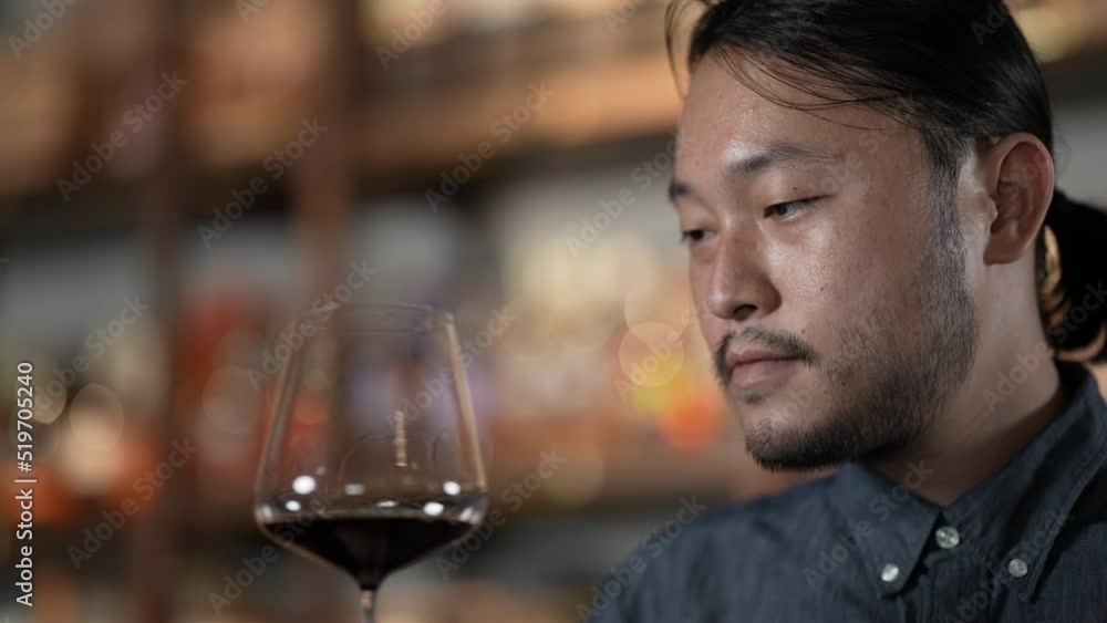 Night club concept of 4k Resolution. Asian man tasting wine in a restaurant. A group of specialized clubs that sell alcoholic beverages. Night club concept of 4k Resolution. Asian man tasting wine in a restaurant. A group of specialized clubs that sell alcoholic beverages.