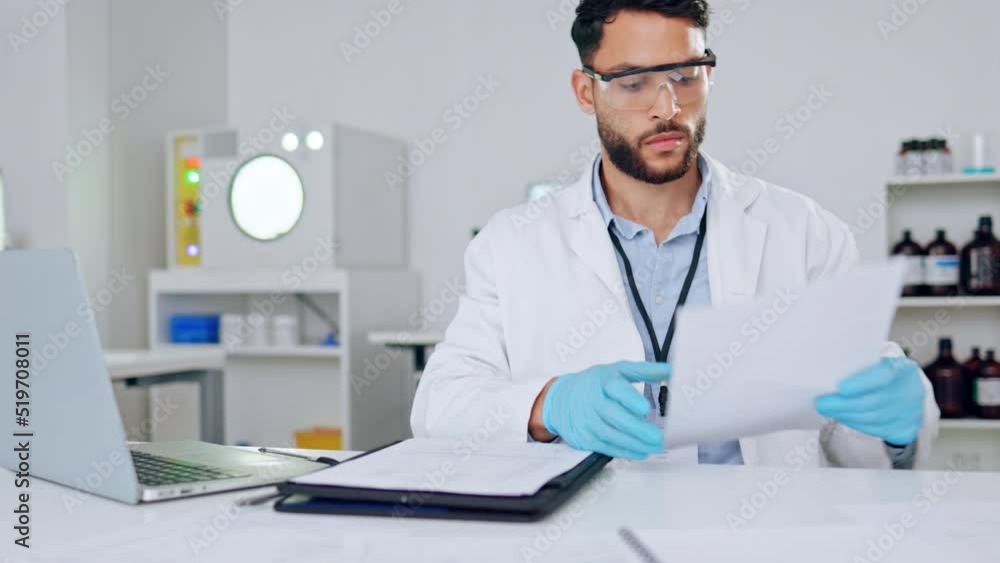 A serious male scientist looking at medical data in a laboratory. A science researcher doing research for a scientific journal. Intelligent lab worker working on a covid cure A serious male scientist looking at medical data in a laboratory. A science researcher doing research for a scientific journal. Intelligent lab worker working on a covid cure