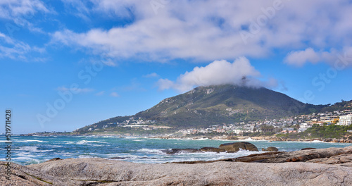 Beautiful view of a blue ocean on the rocky coast of Western Cape, South Africa, against a cloudy sky background with copy space. Soothing, tranquil water in harmony with nature and fresh air