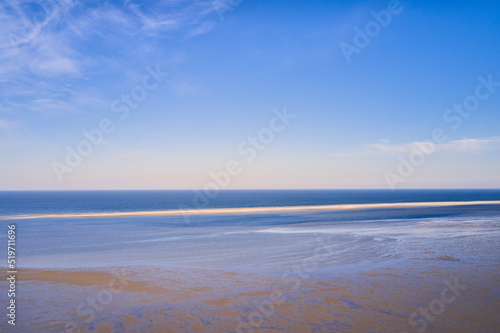 Beautiful landscape of an empty beach against a blue sky background on a summer morning. A peaceful and quiet view of the ocean and the sea shore with copy space on a spring day