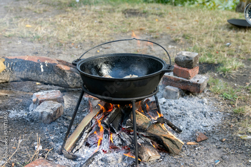 Cauldron on a fire near the river.