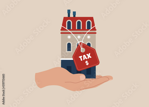 Hand holding house with the price tags showing property tax with dollar signs to pay for. Property tax, real estate or housing payment. 