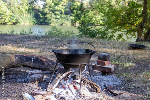  Cauldron on a fire near the river.
