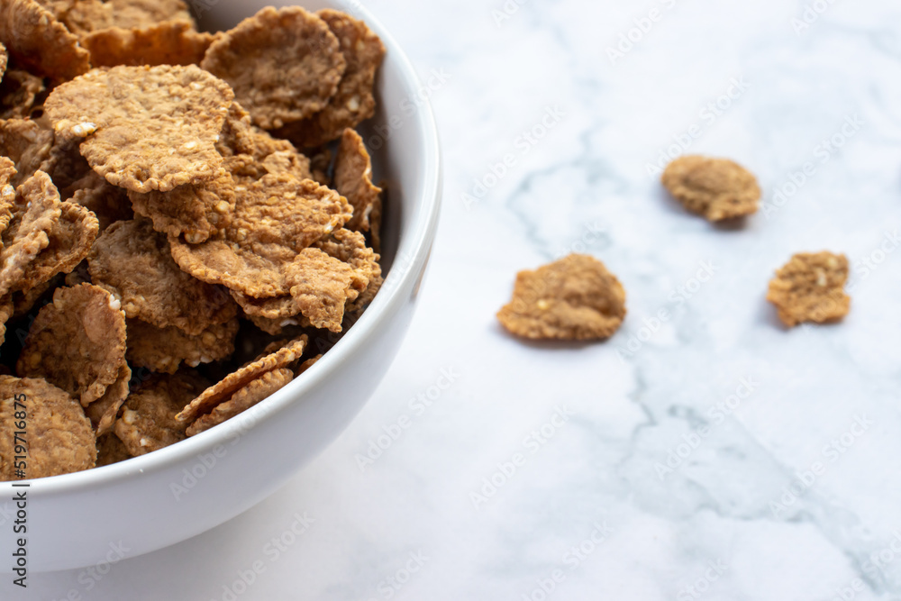Bowl of multigrain cereal with spoon on marble table background. Healthy diet breakfast. Top view, copy space Bowl of multigrain cereal with spoon on marble table background. Healthy diet breakfast. Top view, copy space