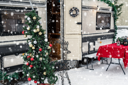 Modern campervan motorhome in winter camping decorated for Xmas or Happy New Year holiday