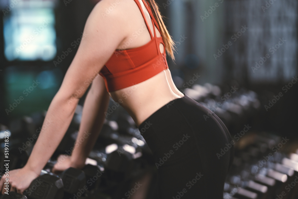 Fototapeta premium young Asian woman person exercise in fitness gym for building a beautiful slim body, healthy training of athletic female in sport lifestyle, attractive girl doing weight active wellness in happy