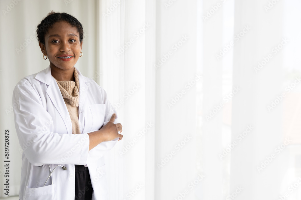 African doctor folded arms pose smiling and looking to something on white background African doctor folded arms pose smiling and looking to something on white background