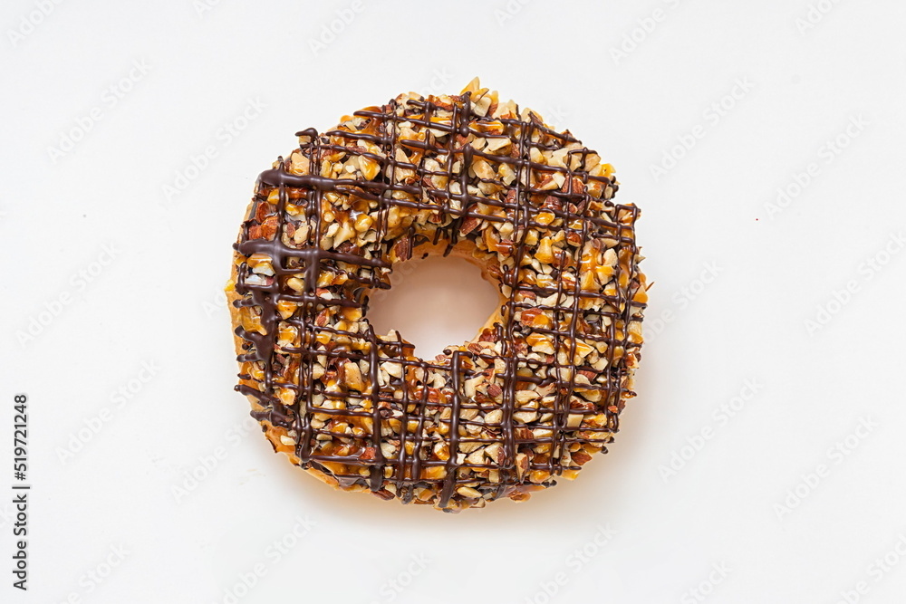 Chocolate donut with frosted glazed and nuts sprinkles top view ...