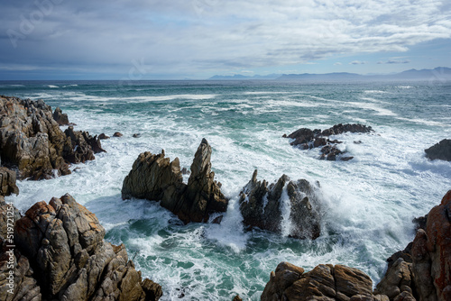 The beautiful coastline at De Kelders with a view across Walker Bay towards Hermanus, Overberg, Western Cape, South Africa. photo