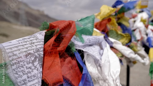 Tibetan Tied Prayer And Blessing Flags On Thiksey Monastery Mountains In Ladakh, India. Close Up, Slow Motion