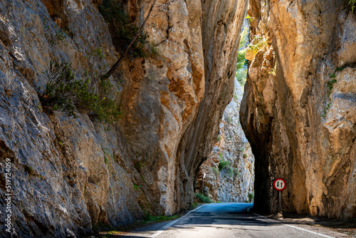 A narrow bottleneck in a dangerous curve of the Serra de Tramuntana mountain road MA-2141 leads through the famous high cliff rock gate Sa Bretxa in the area of Penyal del Cavall Bernat at Mallorca. photo