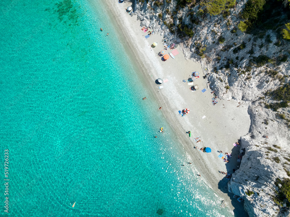 Obraz premium Aerial top view of the beautiful Hovolo beach at the island of Skopelos, Sporades, Greece, with emerald sea and white pebbles