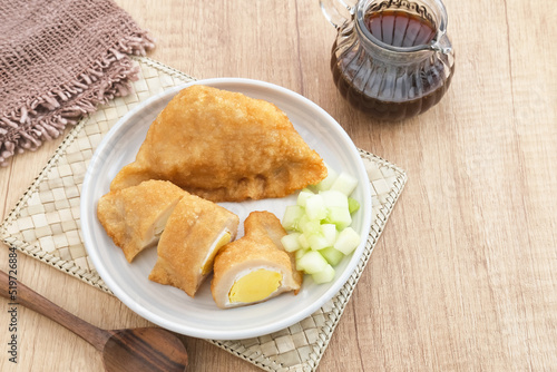 Pempek, Empek-Empek, traditional food from South Sumatra, Indonesia. This fish-based food is very popular. Served with cuko sauce and cucumber slices.
 photo