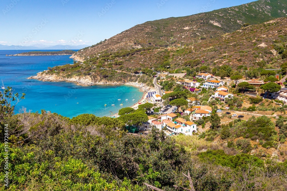 View over colorful bay of little village and sandy beach of Cavoli, Elba Island, Province of Livorno Italy at end of season