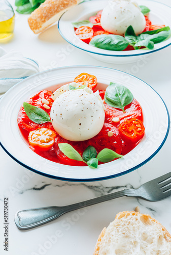 Salad with Tomato, Burrata cheese with basil and olive oil