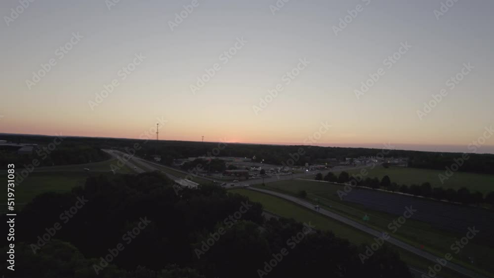Dolly during sunset in small town near highway Dolly during sunset in small town near highway