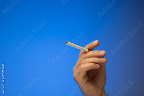 Valokuva An unlit cigarette held in hand by Caucasian male hand
