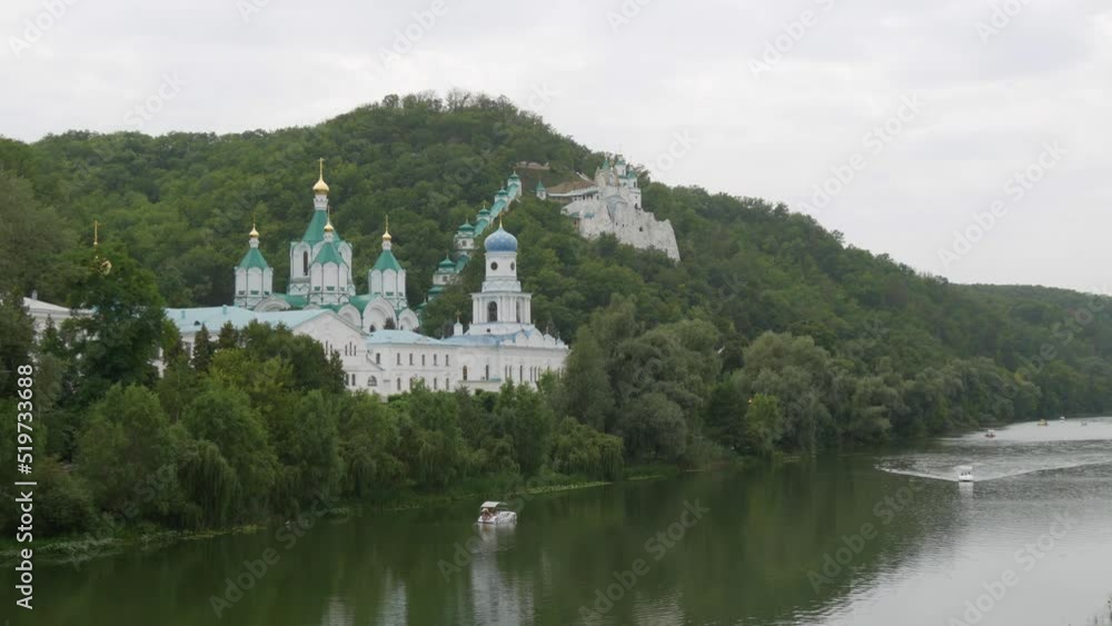 Svyatogorsk Lavra, Donetsk region, Ukraine. A beautiful old monastery is located in the valley of the Seversky Donets River on a mountain around the green foliage of trees Svyatogorsk Lavra, Donetsk region, Ukraine. A beautiful old monastery is located in the valley of the Seversky Donets River on a mountain around the green foliage of trees
