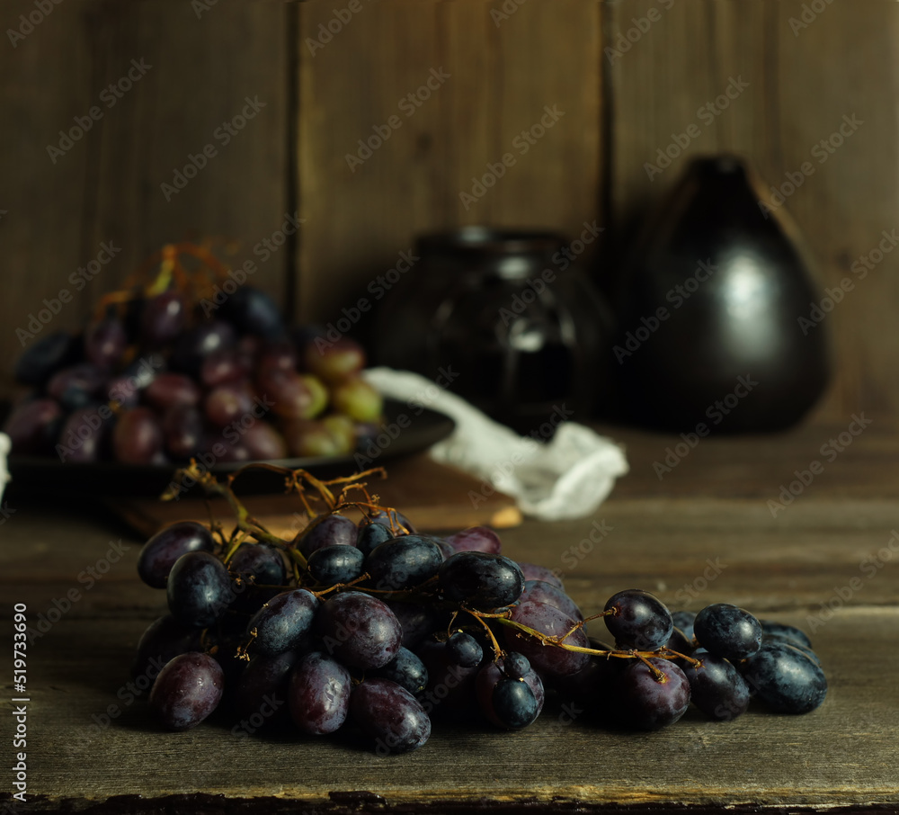 Ripe dark pink grapes on the kitchen table Ripe dark pink grapes on the kitchen table
